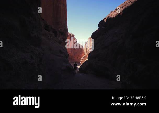 Lone adventurer walks through Natural Bridge Hike Trail in Death Valley ...