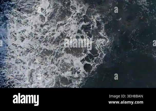 Atlantic Ocean wave front rolling across pebble shoreline, continuous ...