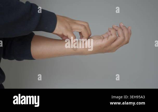 Person uses hand to scratch their arm in a simple setting Stock Video ...
