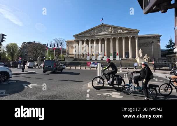 Bicyclist riding past a historic building in an urban environment on a ... - Eco Friendly Urban Construction