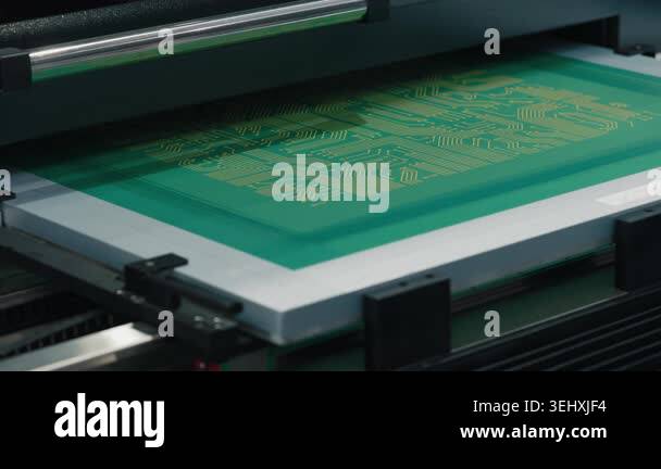 Close-up view of a circuit board being printed, showcasing the green ...