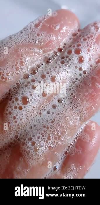 Extreme close up of palm covered in soap bubble foam. Hand hygiene ...