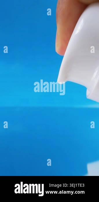 White skin cream coming out from product packaging. White liquid on ...