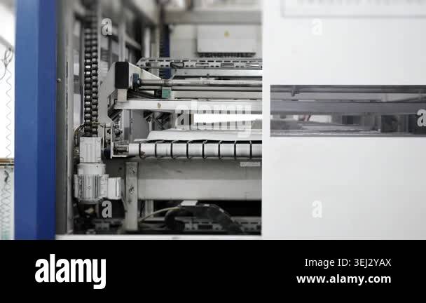 Automated machine laminating wooden furniture panels in factory ...