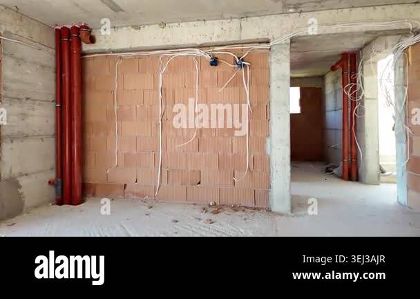 Interior of a house under construction. Exposed electrical wiring and ...