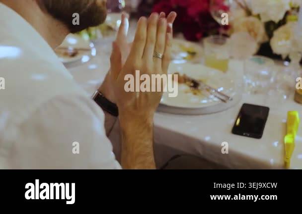 Hands close up of unrecognizable man clapping hands at wedding dinner ...