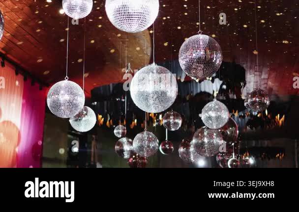 Disco balls hanging on ceiling in wedding decor with mirror spheres ...