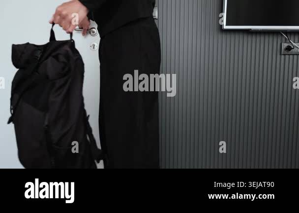 Young man leaving apartment with backpack before work, daily routine ...