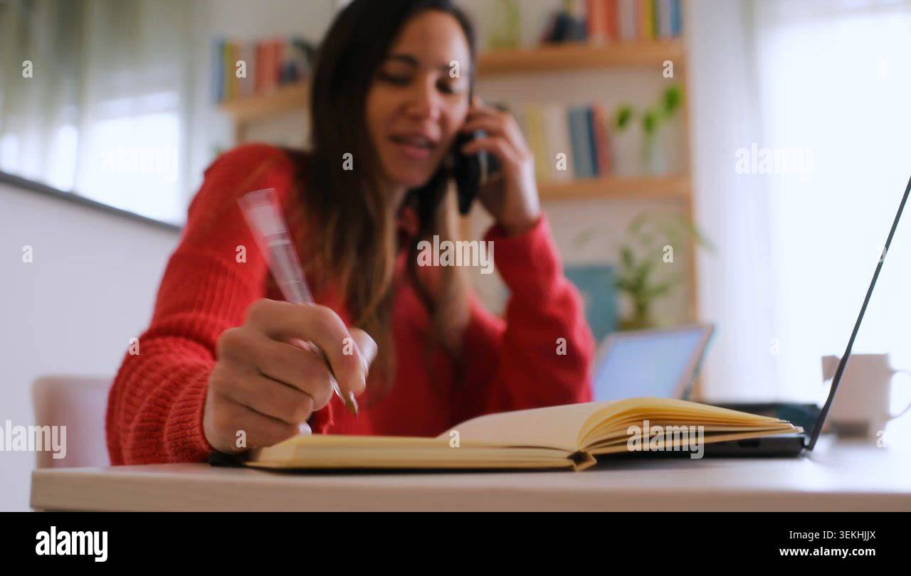 Cheerful Woman Multitasking at Home Desk Stock Video Footage - Alamy