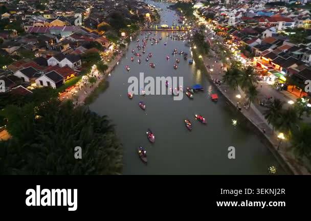 Aerial view of Hoi An ancient town after sunset. Illuminated embankment ...