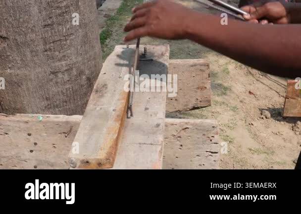 Worker Using Manual Rod Bender to Shape Steel Rebar at Construction ...