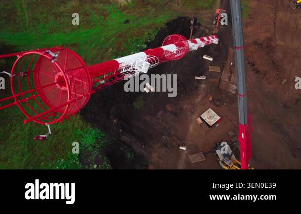 Aerial top-down view of a long red and white lattice tower lying across ...