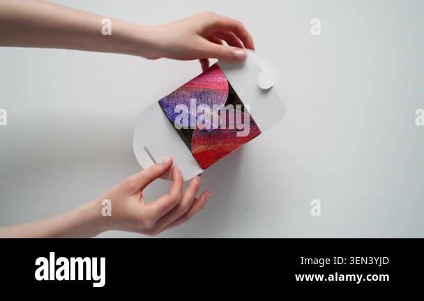 Overhead shot of womans hands opening a recyclable takeout box ...