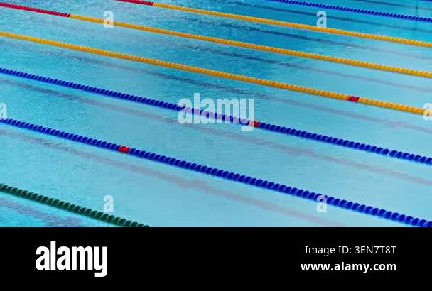 Empty olympic swimming pool lanes with blue and yellow float dividers ...
