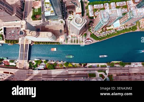 Diverse vessels move by the narrow Chicago River. Drone rising over ...