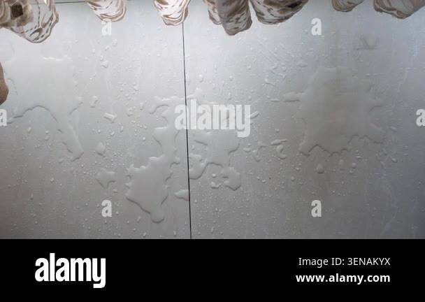 Water is dripping down a wall in a bathroom environment Stock Video ...