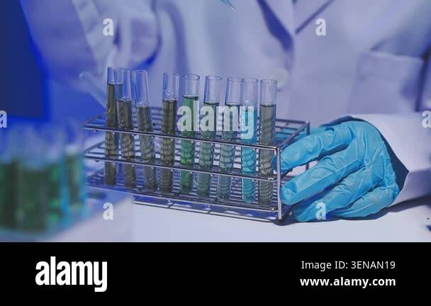 scientist holding test tubes with liquid in laboratory Stock Video ...