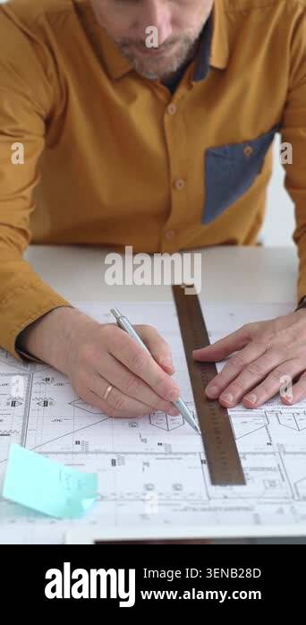 Architect or engineer meticulously drawing and analyzing detailed ...