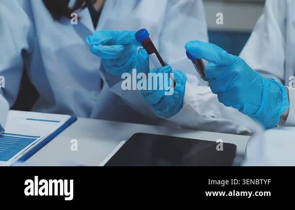 scientist in lab holding sample tube with blood sample Stock Video ...