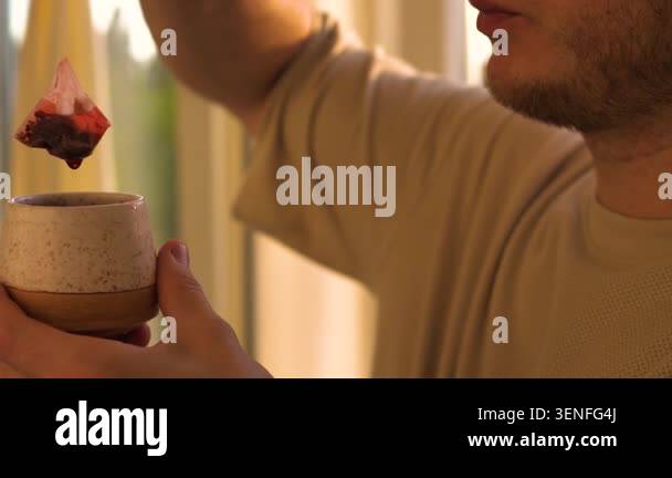 Portrait of a man drinking tea from a cup, close-up of drinking a tea ...