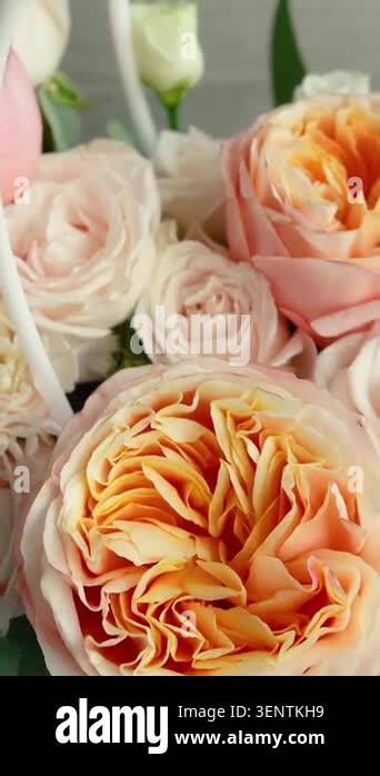 A beautiful romantic bouquet of unusual white roses in a handbag. A ...