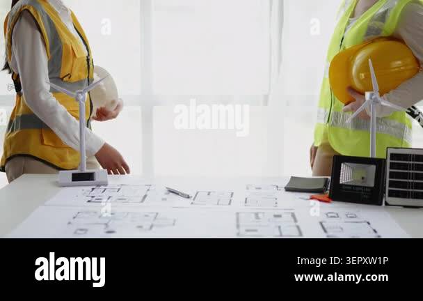 Two engineers discussing plans on table Stock Video Footage - Alamy