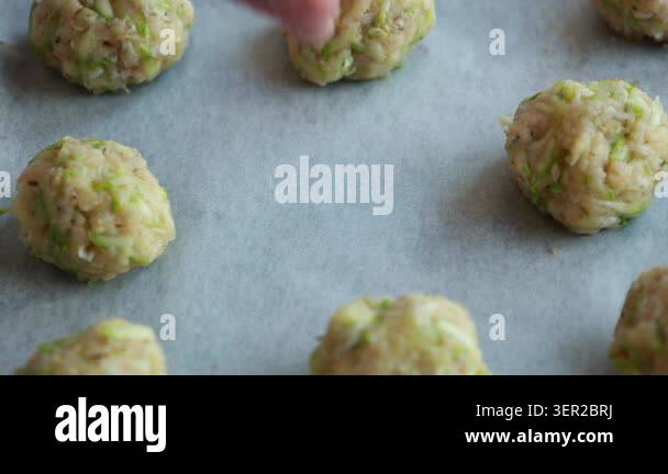 Close-up of raw, unbaked zucchini tots arranged in neat rows on a ...