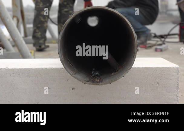 Close-up of an open metal water pipe prepared for repair, showing a ...