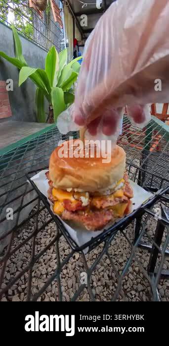Cinematic Video of Golden burger rests on wire tray. Grilled patty and ...