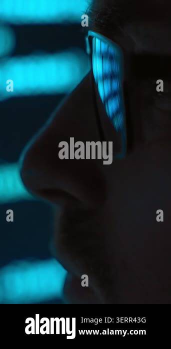 Side view close up, focused software engineer in eyeglasses looking at ...