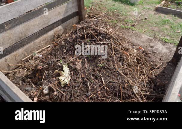Adding organic waste to compost pile in slow motion. High quality ...