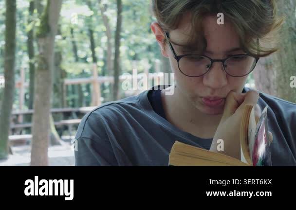 Young Girl is Reading a Book Outdoor Stock Video Footage - Alamy