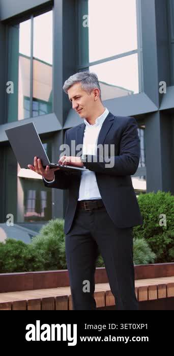 Handsome older man entrepreneur using wireless pc remotely computer for ...