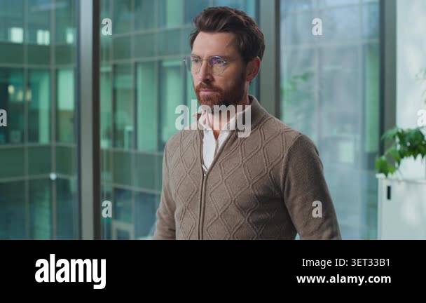 Portrait Caucasian business man looking at camera holding glasses ...