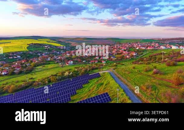 Solar panel array near a rural village, Bulgaria. Aerial drone ...