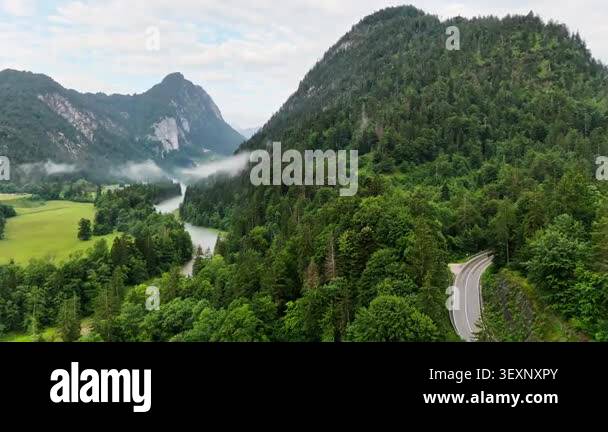 Wide view of green meadows, forests and rocky peaks of the Bavarian ...