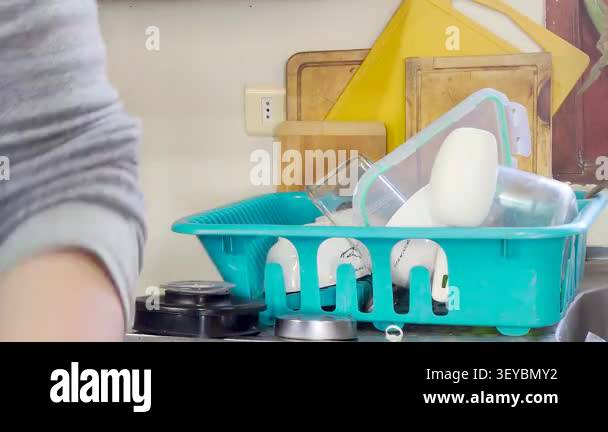 Side View Timelapse of Emptying Kitchen Dish Drying Rack Removing Clean ...