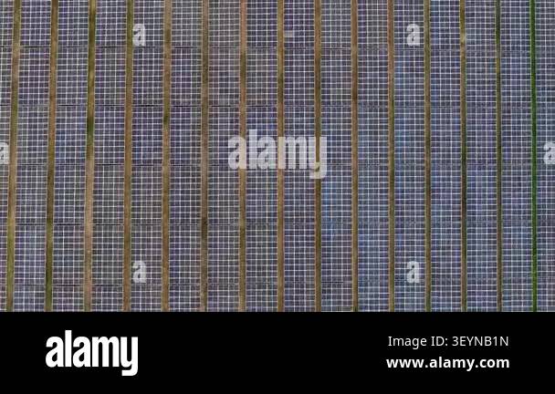 Aerial shot of rows of solar panels in a ground mounted solar farm ...