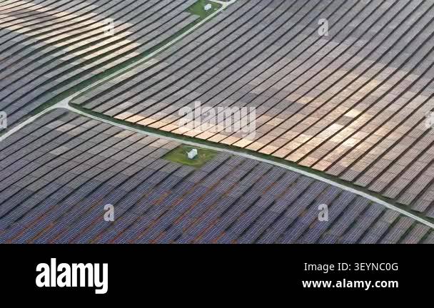Aerial shot showing rows of photovoltaic panels and service roads in a ...