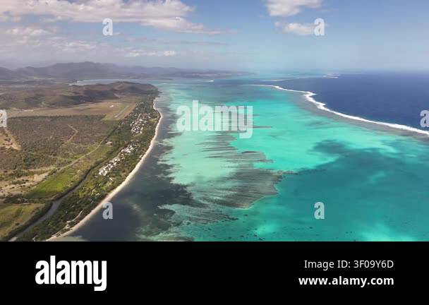Aerial turquoise lagoon coastline in New Caledonia showcasing coral ...