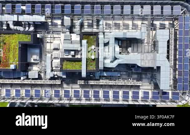 Aerial view of modern business building rooftop featuring solar panels ...