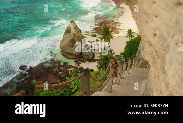 Stone staircase with rope railing leads down cliffside to Diamond Beach ...
