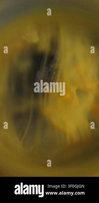 Vertical video. Smoke defocused vortex. Art fume. Yellow paint drop ...