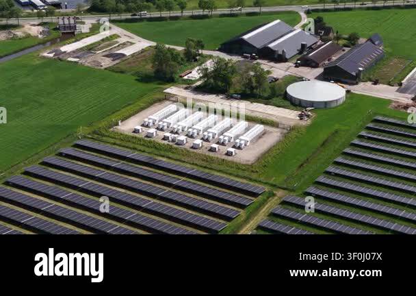 Aerial view of a modern solar farm with panels and a battery energy ...