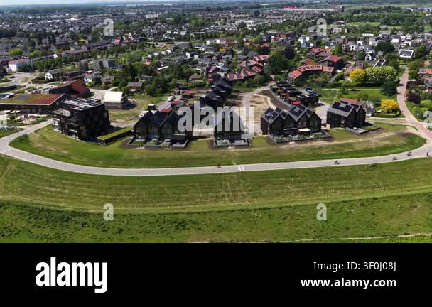 High angle drone perspective flying over a modern residential area with ...