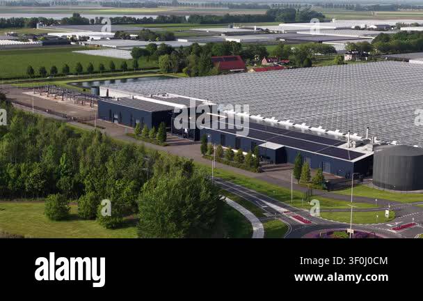 Expansive aerial view showcasing a large scale, modern greenhouse ...