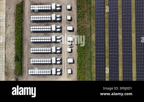 Top down aerial view of a solar farm with rows of photovoltaic panels ...