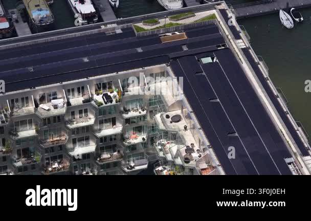 Contemporary apartment building with rooftop solar panels and ...