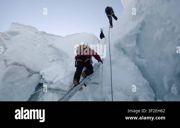 Sherpas And Climbers Crossing The Dangerous Khumbu Icefall On Their Way 