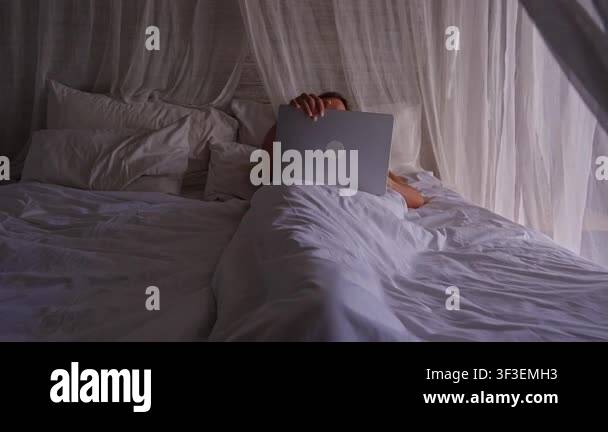 Woman Tossing Laptop Aside and Turning Away to Continue Sleeping in ...
